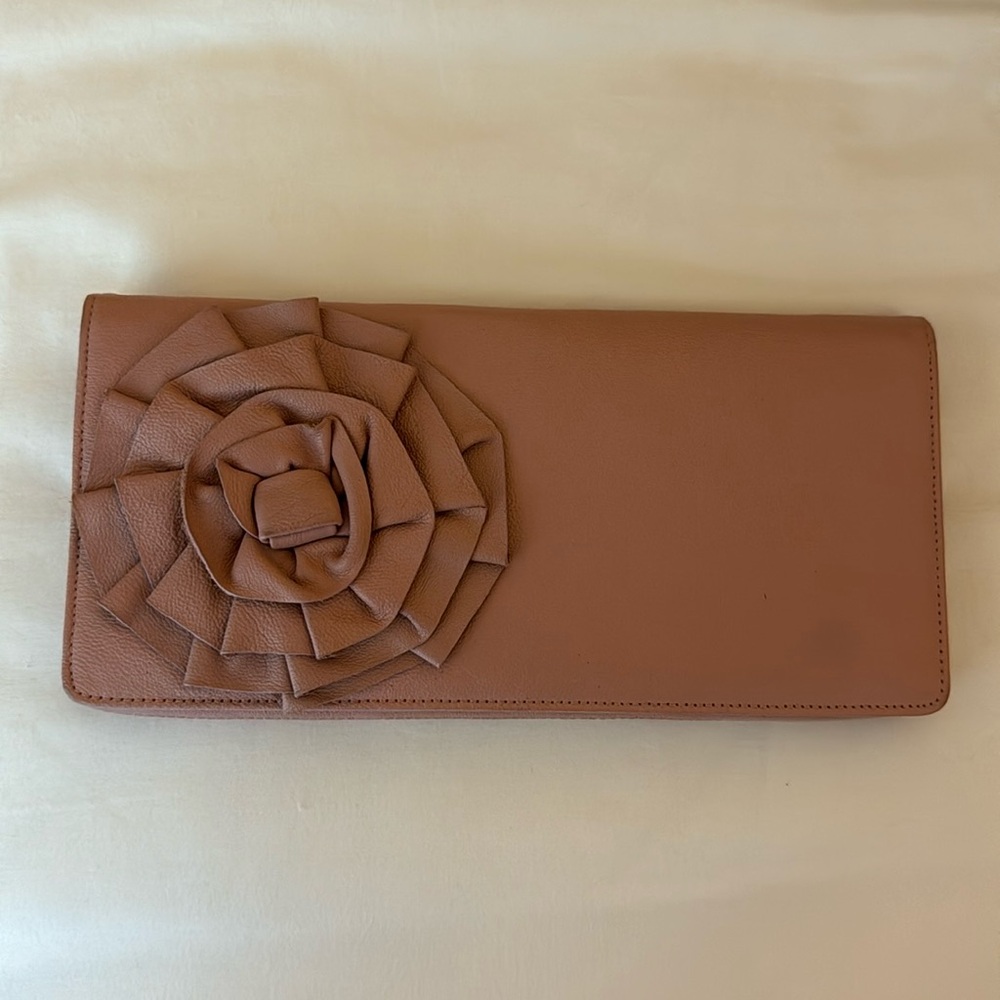 Tarnish rose pink clutch with flower in the front.